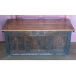 An early 18th century oak coffer, with replacement lid, carved decoration to the lid and a