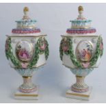 A pair of Meissen porcelain covered vases, of shaped hexagonal form, encrusted with leaf swags and