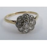A nine stone diamond cluster ring, stamped '18ct Plat' the old brilliant cuts totalling