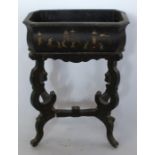 A 19th century papier mache plant stand, the rectangular trough decorated with Oriental figures, the