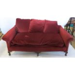 A red upholstered settee, with serpentine back rail. raised on short cabriole front supports, length