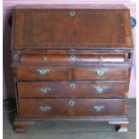 An 18th century walnut bureau, fitted with a curvetto drawer below the fall flap, over two short and