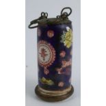 An Oriental cylindrical porcelain pot, decorated with fish, flowers and script to a blue ground,