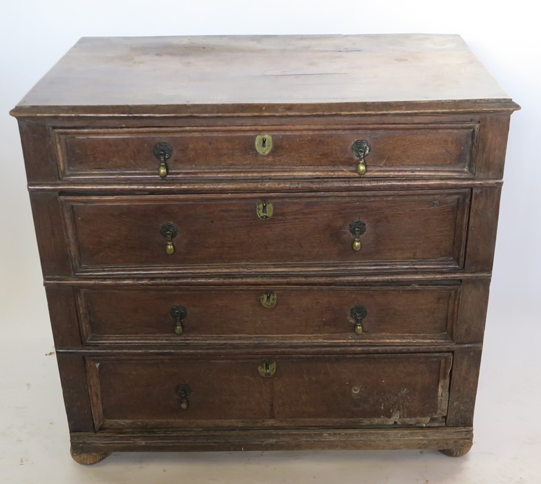 An Antique oak chest, of four long graduated drawers, with moulded fronts, width 36.5ins, height