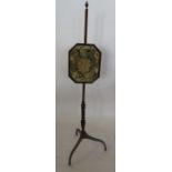 A 19th century mahogany pole screen, the octagonal screen with embroidered floral panel, on a