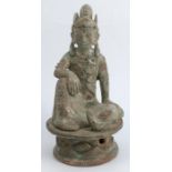 An oriental model, of a seated Eastern figure with a bird on a pierced base, height 8.