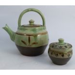 A Winchcombe Pottery tea kettle, together with covered jam pot, both slip decorated on a pale