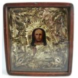 A cased and framed icon, with gilt metal cover decorated with foliage surrounding the portrait of