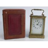 A carriage clock, with gilt metal and glass case, with white enamel dial and Roman numerals,