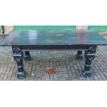A painted Gothic style refectory table, raised on four carved and turned legs, with cleated top,