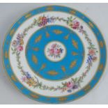 A Sevres porcelain plate, decorated with flowers and leaves with a powder blue ground, diameter 9.