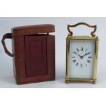 A carriage clock, with gilt metal and glass case, with white enamel dial and Roman numerals,