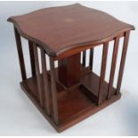 An Edwardian mahogany and inlaid book stand, of shaped square form, 13ins x 13ins x 13ins