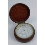 An Asprey London cased compensated barometer, the textured leather circular case, with hinged lid,