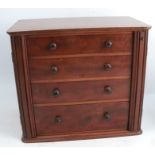 A 19th century mahogany table top bank of drawers, the four graduated long drawers having hinged