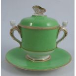 A Spode porcelain covered cup and stand, decorated with an apple green ground, a butterfly finial