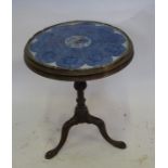 A late 18th century / early 19th century mahogany circular table, with a turned column raised on a