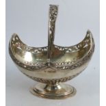 A silver oval basket, with swing handle, having pierced decoration and a gadrooned lower body,