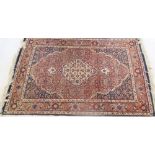 An Eastern design rug, decorated with flower heads and other repeating motifs, 67ins x 41ins