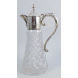 A silver mounted and cut glass claret jug, the mount with engraved decoration of crest and