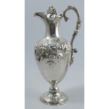 A 19th century silver claret jug, of baluster form, with vine finial to the hinged cover, vine