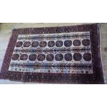 An Eastern design rug, decorated with repeating motifs, 62ins x 36ins