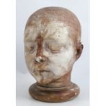 A 19th century plaster death mask, of a child, impressed A731 to back, height 10ins