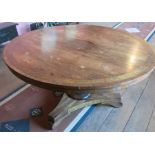 A Regency rosewood circular breakfast table, with cut brass central panel and border, with further