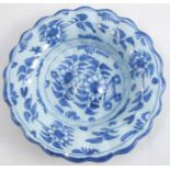 An 18th century Brislington delftware dish, painted in blue with a Chinese flower pot, diameter 8.