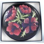 A Moorcroft pottery wall plate, decorated in the Anemone pattern, diameter 10ins, boxedCondition