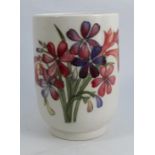 A Moorcroft pottery cylindrical vase, decorated in the Spring Flowers and Orchid pattern, paper