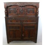 An Antique style oak court cupboard, with carved decoration to the whole, width 41ins, height 54ins