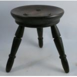 A 19th century dairy stool, the dished circular seat raised on three turned legs, diameter 11ins,
