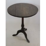 An Antique oak occasional table, the circular fixed top raised on a baluster column to three