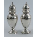 A pair of silver casters, of baluster form, raised on a circular pedestal foot, London 1907,