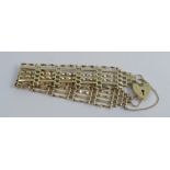 A 9 carat gold bracelet, of six bar gate links design, to a padlock clasp, 13g gross