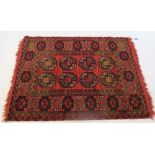 An Eastern design rug, the field decorated with eight repeating motifs, 56ins x 40ins