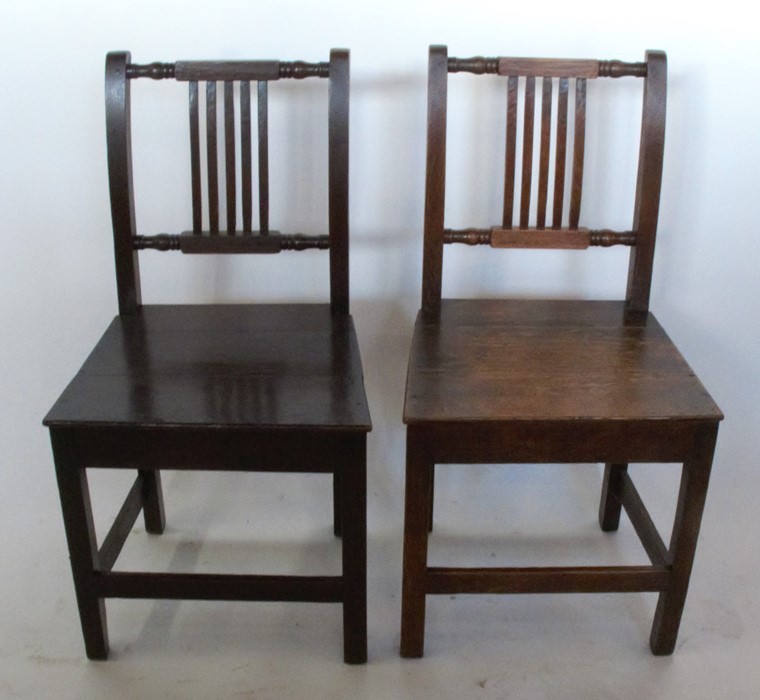 A set of four 19th century oak dining chairs, with carved and slat backs over solid seats