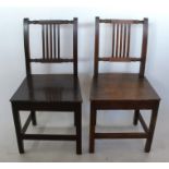 A set of four 19th century oak dining chairs, with carved and slat backs over solid seats