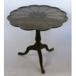 A 19th century mahogany tilt top table, the circular top with lobed edge having carved decoration,