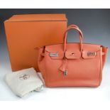 A Hermes Birkin 35 handbag, in orange leather, with dust bag and cardboard box