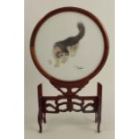 A circular Oriental embroidery panel, of a cat and a grasshopper, signed with characters, diameter