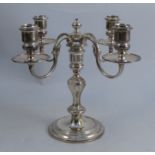 A silver candelabrum, having four scroll branches, raised on a column to a circular base, Birmingham