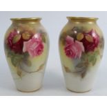 A pair of Royal Worcester vases, decorated with roses by Hunt, shape number G461, one damaged,