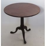 An Antique mahogany occasional table, the circular fixed top raised on a column to three outswept