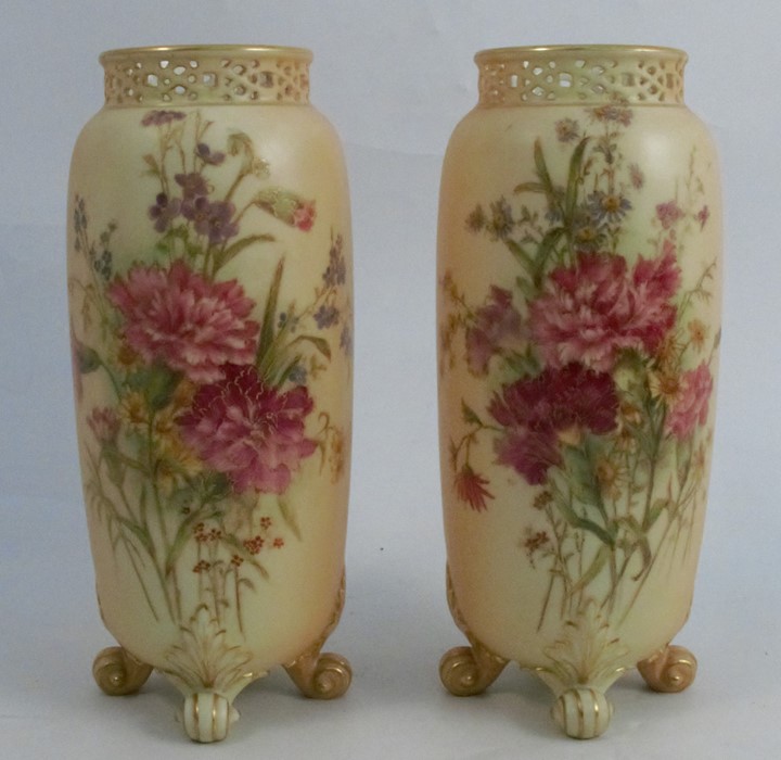 A pair of Royal Worcester blush ivory vases, with pierced necks and decorated with floral sprays,