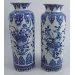 A pair of Chinese Kangxi style vases, decorated in blue and white with flowers, artemisia leaf