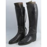 A pair of black leather riding boots, together with wooden tees having a Maxwell London mark