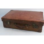 A Finnigans leather suitcase, stamped to the side and interior, 22.5ins x 13.5ins x 6.