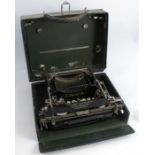 A cased Corona Typewriter Company Inc folding typewriter